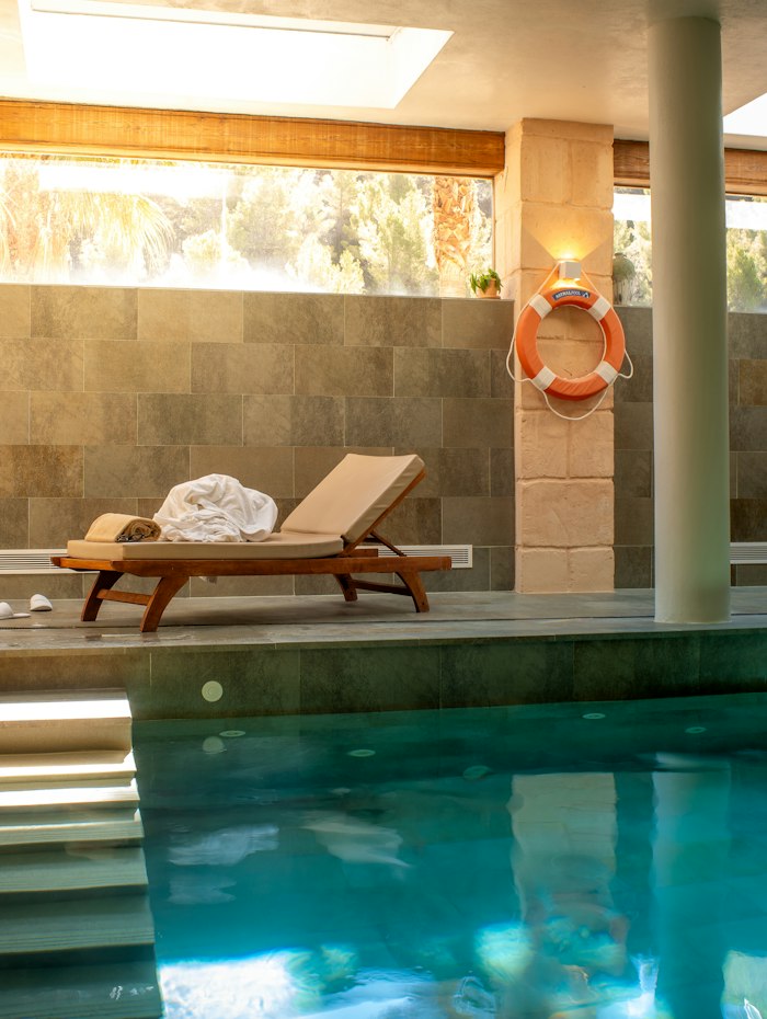 Indoor pool and lounge chairs at the spa