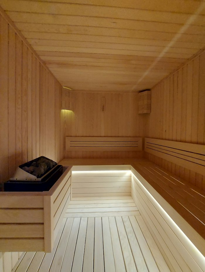Wooden sauna benches with warm lighting