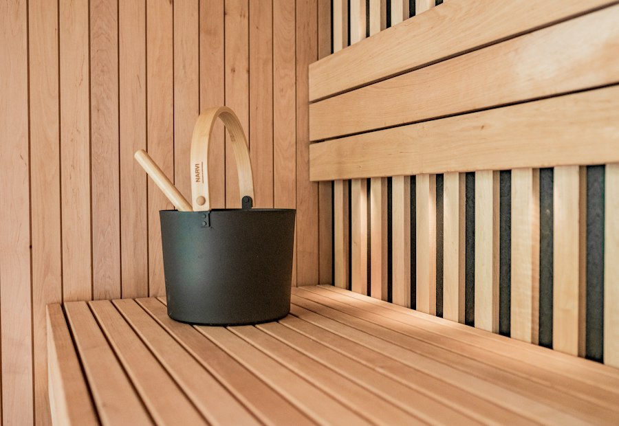 Wooden sauna with a bucket and two ladles