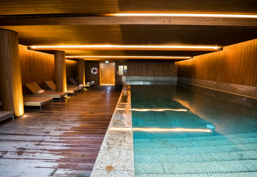 Indoor pool lounge with wooden walls