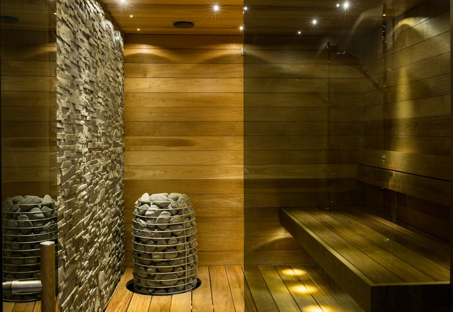 Wooden table against a concrete spa wall