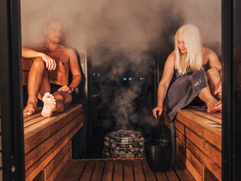 Guests relaxing in a heated sauna cabin